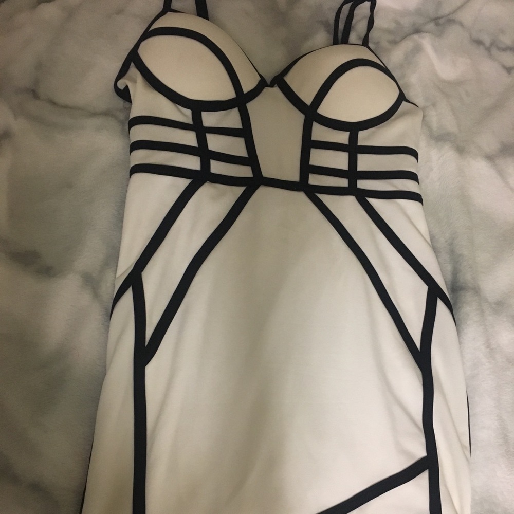 White body-con dress with black detailing.